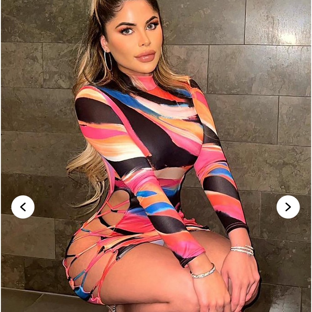 Cute pink multicolor mini dress with open side profile. Sexy for a night out!